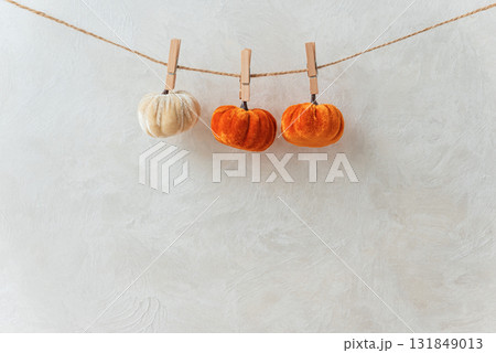 Autumn Garland with Leaves, Pumpkins, Berries, and Lights on Textured Wall 131849013