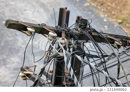 Old, abandoned electric pole, The electric post show with high voltage construction and power lines. Old, abandoned electric pole, The electric post show with high voltage construction and power lines. 131849062
