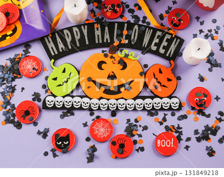 Happy halloween greetings decor with pumpkins on purple orange background 131849218