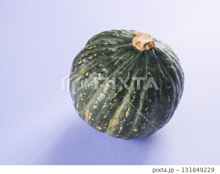 Green pumpkin on purple background Green pumpkin on purple background 131849229