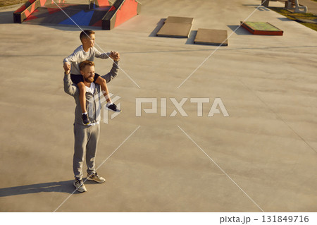 Father And Son Exercising In City Park Father And Son Exercising In City Park 131849716
