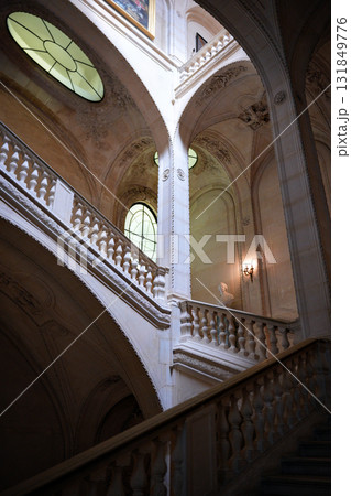 Architectural staircase with arches and natural light Louvre Museum Paris France 131849776