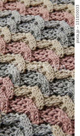 Colorful knitted fabric with interwoven texture featuring pink, grey, and beige patterns Colorful knitted fabric with interwoven texture featuring pink, grey, and beige patterns 131850033