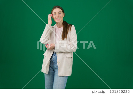 Set of photos of young European woman in light blazer and blue jeans showing various emotions gestures and expressions on green chroma key background with copy space for advertising and social media Set of photos of young European woman in light blazer and blue jeans showing various emotions gestures and expressions on green chroma key background with copy space for advertising and social media 131850226