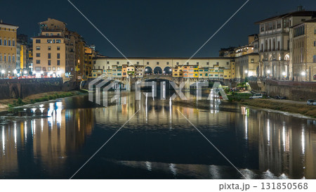 Famous Ponte Vecchio bridge timelapse over the Arno river in Florence, Italy, lit up at night 131850568