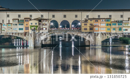 Famous Ponte Vecchio bridge timelapse over the Arno river in Florence, Italy, lit up at night 131850725