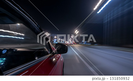 Drivelapse urban look from fast driving car at a night avenue in a city timelapse hyperlapse 131850932