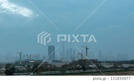 Skyline of construction cranes tower with skyscrapers on background in the Middle East day to night timelapse, Dubai Skyline of construction cranes tower with skyscrapers on background in the Middle East day to night timelapse, Dubai 131850977