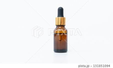 Amber glass dropper bottle with gold cap, isolated on white background, ideal for essential oils or cosmetic product mock up with copy space Amber glass dropper bottle with gold cap, isolated on white background, ideal for essential oils or cosmetic product mock up with copy space 131851094