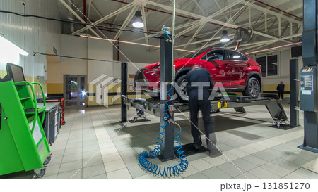 Car on stand with sensors on wheels for wheels alignment camber check in workshop of Service station timelapse. 131851270