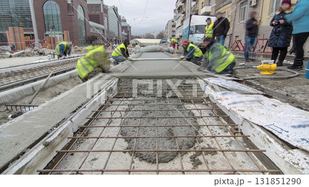 Pouring ready-mixed concrete after placing steel reinforcement to make the road by concrete mixer timelapse hyperlapse. 131851290