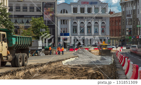 Industrial truck loader excavator moving soil and unloading into a dumper truck timelapse Industrial truck loader excavator moving soil and unloading into a dumper truck timelapse 131851309