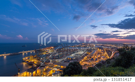 Seaport and loading docks at the port with cranes and multi-colored cargo containers day to night timelapse Seaport and loading docks at the port with cranes and multi-colored cargo containers day to night timelapse 131851417