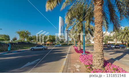 Corniche boulevard beach park along the coastline in Abu Dhabi timelapse hyperlapse with skyscrapers on background. 131851548