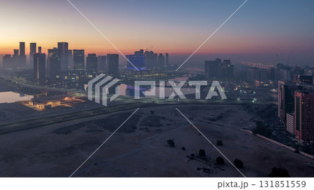 Abu Dhabi city skyline with skyscrapers before sunrise from above night to day timelapse Abu Dhabi city skyline with skyscrapers before sunrise from above night to day timelapse 131851559