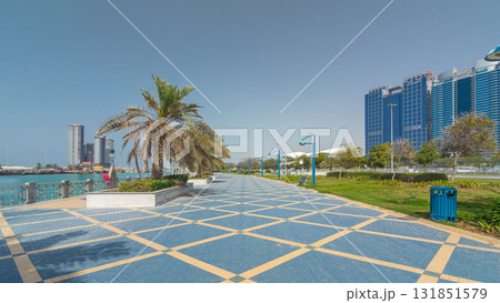 Corniche boulevard beach park along the coastline in Abu Dhabi timelapse hyperlapse with skyscrapers on background. Corniche boulevard beach park along the coastline in Abu Dhabi timelapse hyperlapse with skyscrapers on background. 131851579
