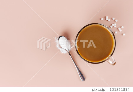 A cup of coffee with milk and a spoonful of natural stevia sweetener. Top view. Copy space. A cup of coffee with milk and a spoonful of natural stevia sweetener. Top view. Copy space. 131851854