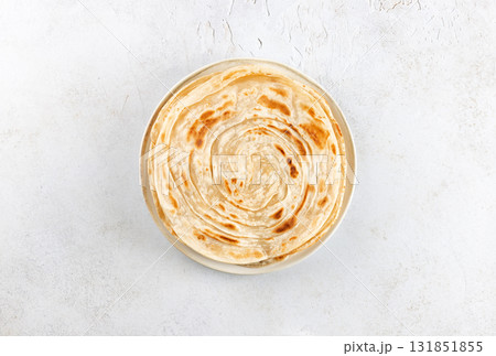 Traditional Indian paratha on white background. Indian food. Top view. Traditional Indian paratha on white background. Indian food. Top view. 131851855