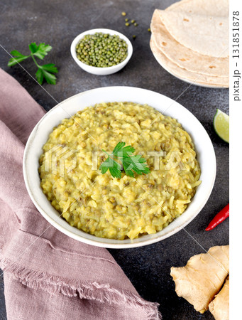 Indian Khichari with rice,lentils served with roti on gray background. Top view. Ayurveda diet 131851878