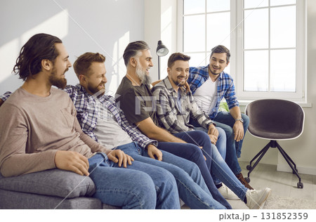 Group of close friends sitting on sofa at home 131852359