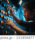 close up of engineer adjusting controls with oil on his hands, showcasing concentration and expertise in dimly lit environment. scene conveys sense of urgency and focus 131856877