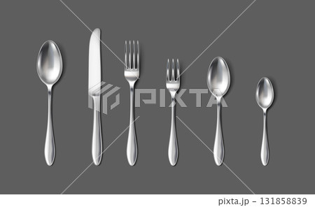 Set of Metallic Flatware on Dark Gray Background 131858839