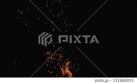 sparks and embers from campfire flying over black background sparks and embers from campfire flying over black background 131860055