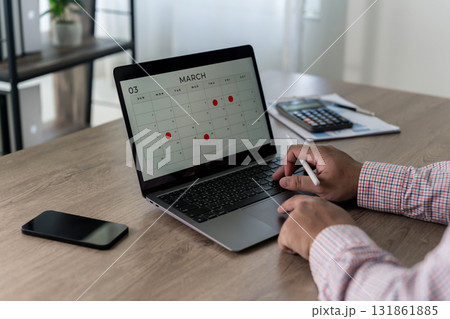 planning schedule on laptop, marking dates and appointments business agenda, deadlines, and meeting reminders organized for productivity at a modern workspace time blocking planner 131861885