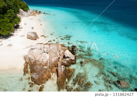 A beautiful tropical beach on the island of Lang Tengah in Malaysia with clear turquoise water and large stones on a sunny day A beautiful tropical beach on the island of Lang Tengah in Malaysia with clear turquoise water and large stones on a sunny day 131862427