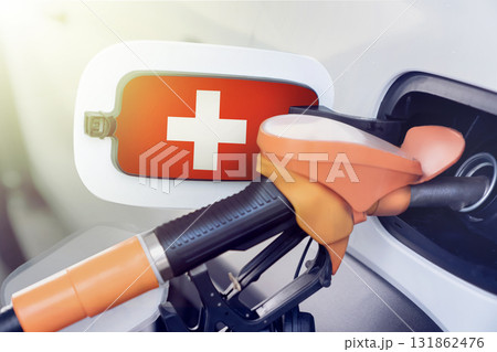 The Switzerland flag on the lid of the gas tank of a car at a gas station in close-up. High or low prices for gasoline and diesel fuel at Swiss gas stations. fuel shortage for cars in Switzerland. The Switzerland flag on the lid of the gas tank of a car at a gas station in close-up. High or low prices for gasoline and diesel fuel at Swiss gas stations. fuel shortage for cars in Switzerland. 131862476