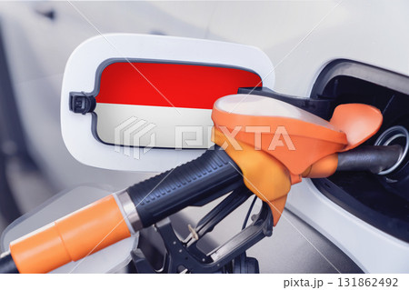 The flag of Indonesia on the lid of the gas tank of a car at a gas station in close-up. High or low gasoline prices at Indonesian gas stations. Problems with the quality of gasoline and diesel fuel 131862492