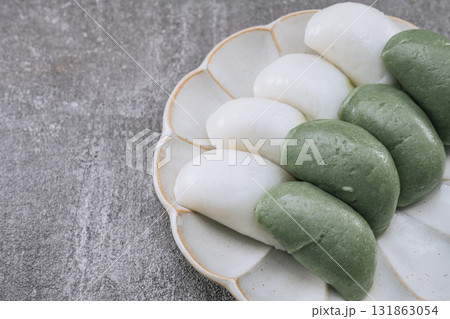 jeolpyeon, korean style Patterned Rice Cake, Short grain rice powder sieved and pressed into a rice cake mold. Unlike other rice cakes made with non-glutinous rice, jeolpyeon is quite chewy and often  131863054