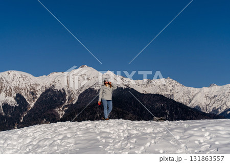 Woman Hiking Snowy Mountains Winter Alps: Solo trek scenic view, sunny day. Woman Hiking Snowy Mountains Winter Alps: Solo trek scenic view, sunny day. 131863557