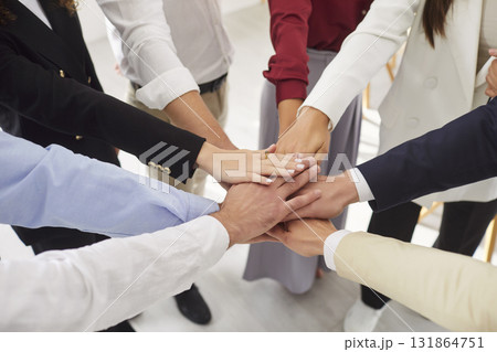 Hands of diverse business people giving high five close up, team members giving help unity  131864751