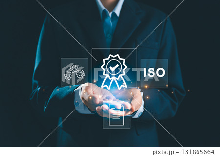 Person holding certificate icon represents concept of certification and standardization, business achieves ISO certified status quality assurance process in conformity with international standards. 131865664