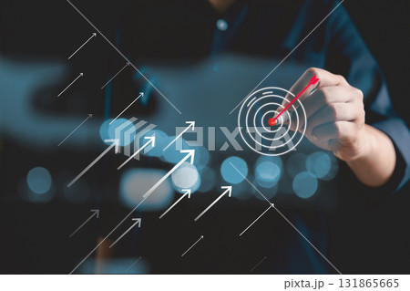 Businessperson touching virtual dartboard with arrow, Business achievement objective target concept. strategy and support of technology, business aims its arrow toward target market, growth, success. Businessperson touching virtual dartboard with arrow, Business achievement objective target concept. strategy and support of technology, business aims its arrow toward target market, growth, success. 131865665