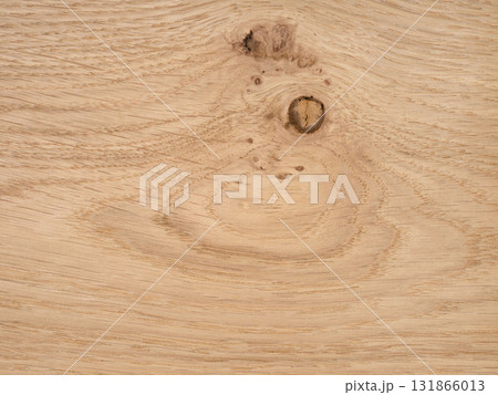 Rustic European oak veneer with a distinct knot and swirling grain patterns 131866013