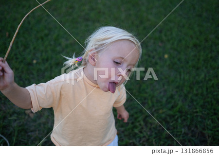 Blonde girl playing outside in summer Blonde girl playing outside in summer 131866856