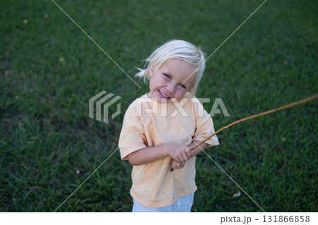 Blonde girl playing outside in summer 131866858