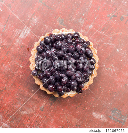 Tartlets with blueberries on vintage background top view. 131867053