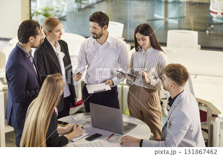 Group of business people working with financial documents during a meeting in office Group of business people working with financial documents during a meeting in office 131867462