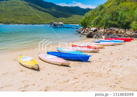 Kayaks on the sandy beach by sea in the blue lagoon in summer on vacation on a sunny day 131868099