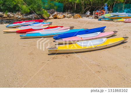 Kayaks on sandy beach by the sea in in summer on vacation Kayaks on sandy beach by the sea in in summer on vacation 131868102