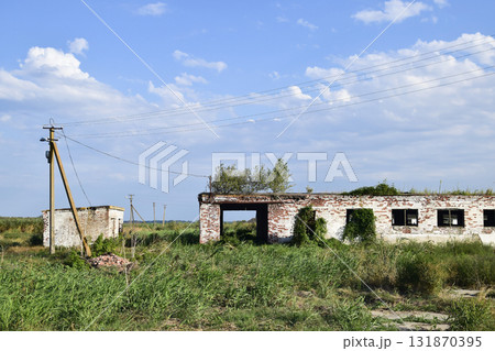 The ruins of the old farm. Cones column base of the wall. Abandoned and ruined buildings 131870395