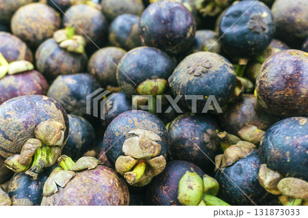 Bunch of black and brown fruit with green stems Bunch of black and brown fruit with green stems 131873033