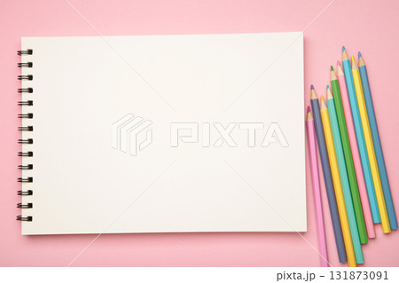 Sketchbook and colored pencils on pink background 131873091