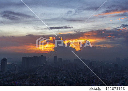 The sky is orange and the clouds are white 131873168