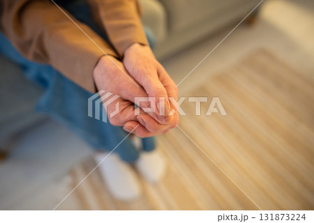 Anxious woman with crossed hands nervously fidgeting, waiting for therapy session in hospital alone Anxious woman with crossed hands nervously fidgeting, waiting for therapy session in hospital alone 131873224