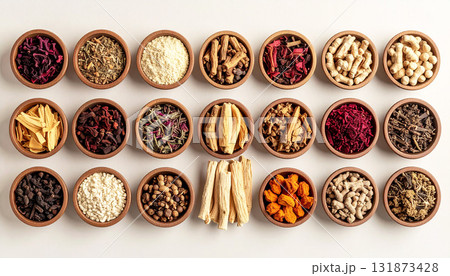 A neatly arranged flat lay of dried adaptogenic roots and herbs such as ashwagandha and rhodiola, displayed in small wooden bowls on a neutral background, symbolizing natural wellness and balance A neatly arranged flat lay of dried adaptogenic roots and herbs such as ashwagandha and rhodiola, displayed in small wooden bowls on a neutral background, symbolizing natural wellness and balance 131873428