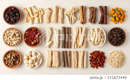 A neatly arranged flat lay of dried adaptogenic roots and herbs such as ashwagandha and rhodiola, displayed in small wooden bowls on a neutral background, symbolizing natural wellness and balance 131873440